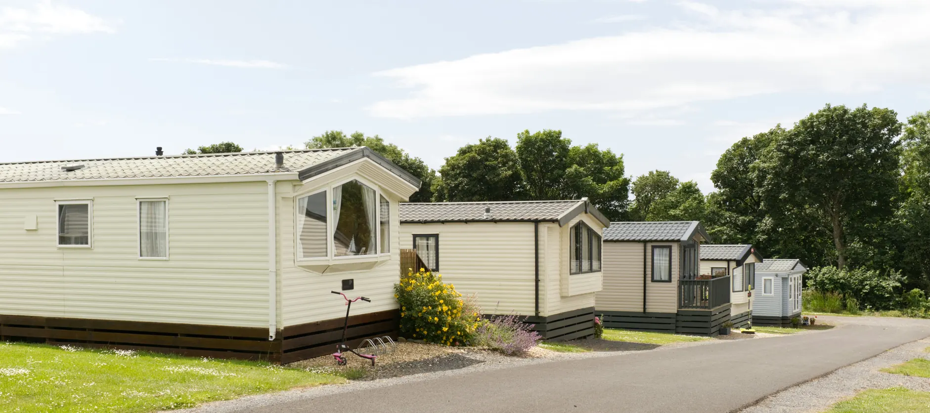 Static holiday caravans beside a landscaped road